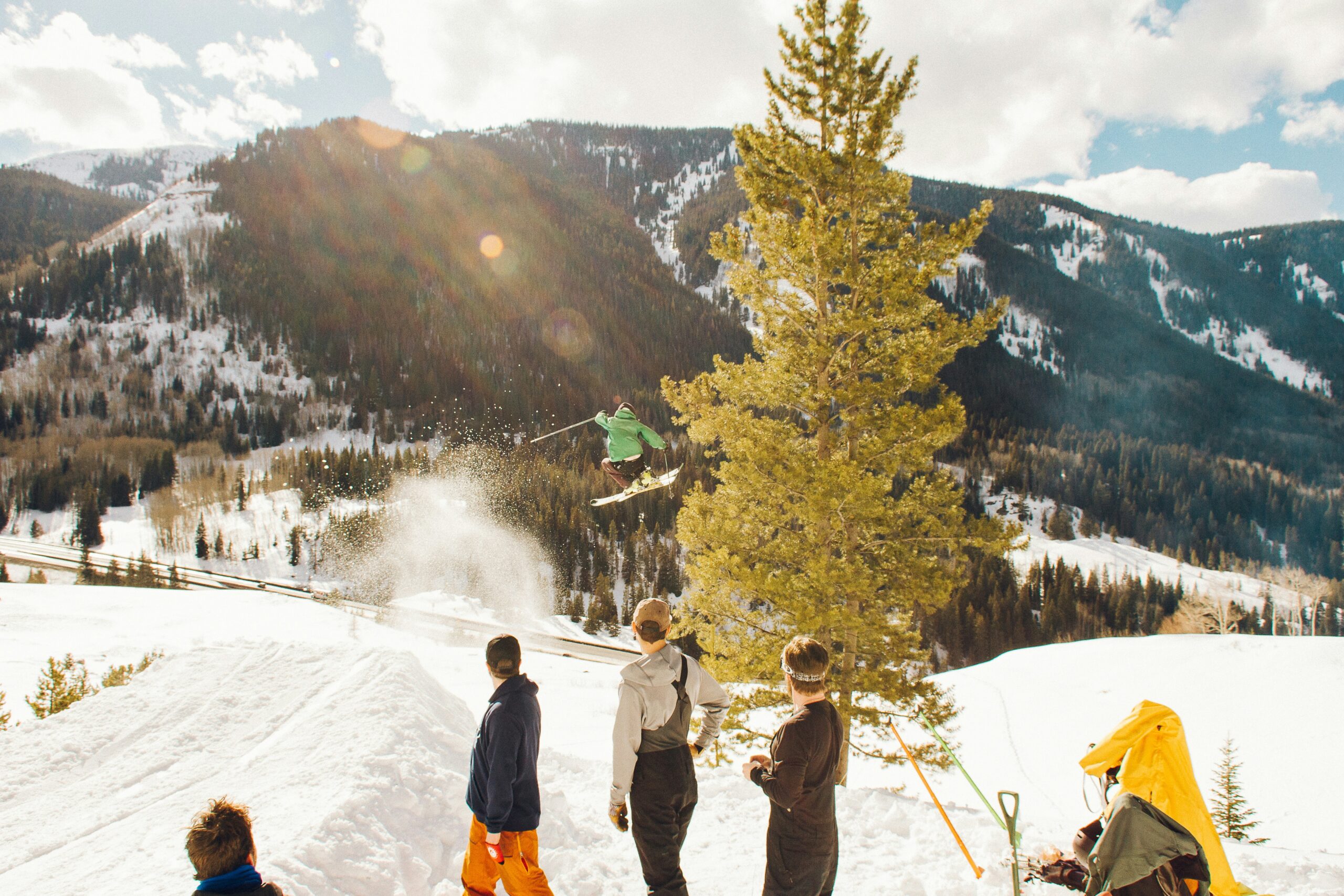 Skiers enjoying a snowy slope at Beech Mountain with direct ski-in/ski-out access from cabins.